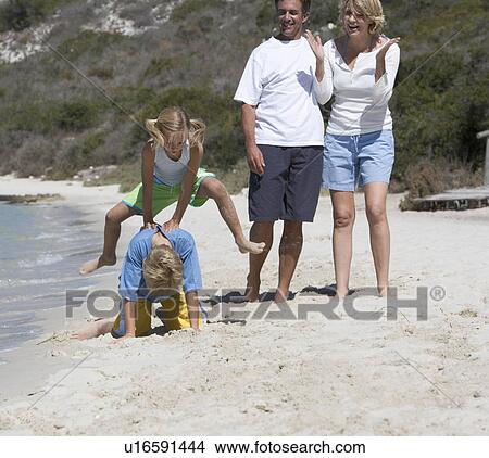 A family on a beach View Large Photo Image Picture - A family on a beach. Fotosearch