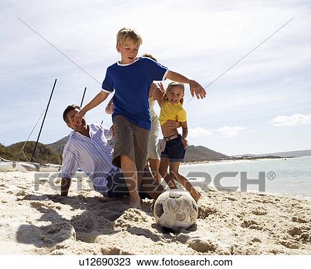 Stock Image - A family on a beach. Fotosearch