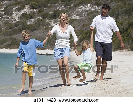 A family on a beach View Large Photo Image Stock Image - A family on a beach. Fotosearch