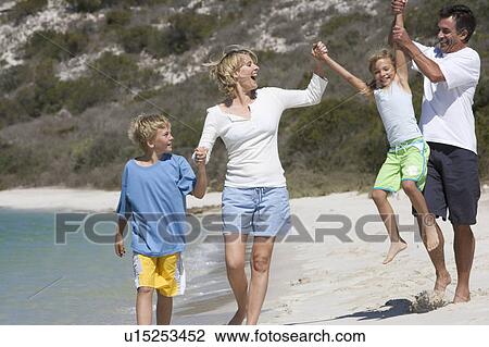 A family on a beach View Large Photo Image Stock Image - A family on a beach. Fotosearch