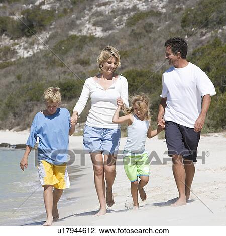 Stock Image - A family on a beach. Fotosearch