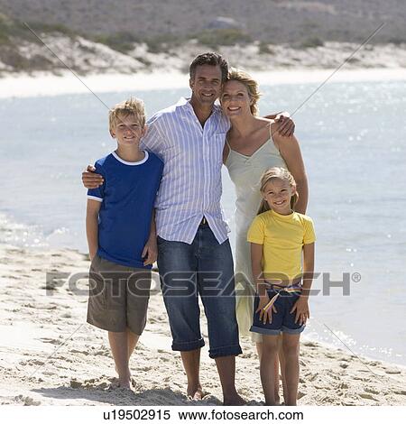 Stock Photography - A family on a beach. Fotosearch