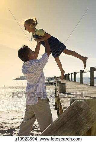 Picture - A father and daughter on a beach. Fotosearch
