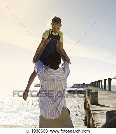 A father and daughter on a beach View Large Photo Image Stock Image - A father and daughter on a beach. Fotosearch