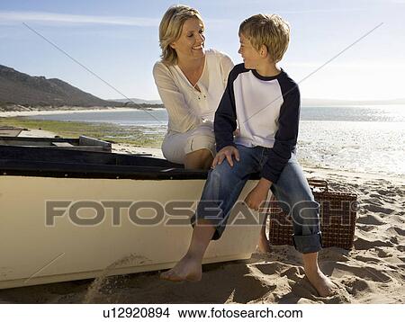 A mother and son sitting on a boat View Large Photo Image Picture - A mother and son sitting on a boat. Fotosearch