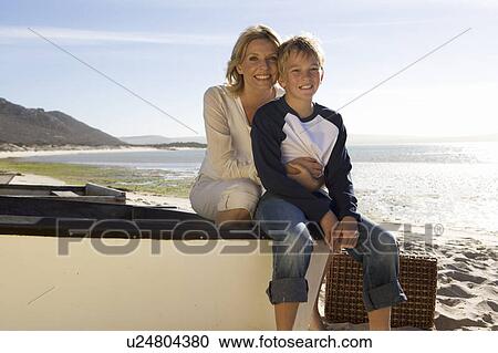 Stock Image - A mother and son sitting on a boat. Fotosearch