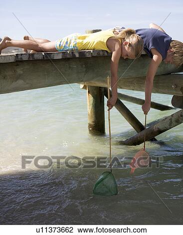 Two children with fishing nets View Large Photo Image Stock Image - Two children with fishing nets. Fotosearch