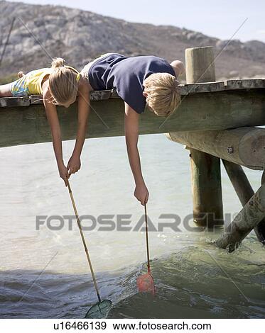 Stock Photo - Two children with fishing nets. Fotosearch