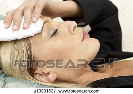 Business woman with a headache, close-up View Large Photo Image Stock Photo - Business woman with a headache, close-up. Fotosearch