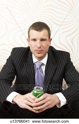 Businessman holding a canned drink View Large Photo Image Stock Image - Businessman holding a canned drink. Fotosearch