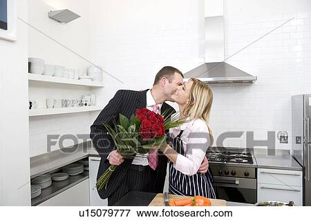 Stock Photo - Businessman presenting his partner with flowers. Fotosearch