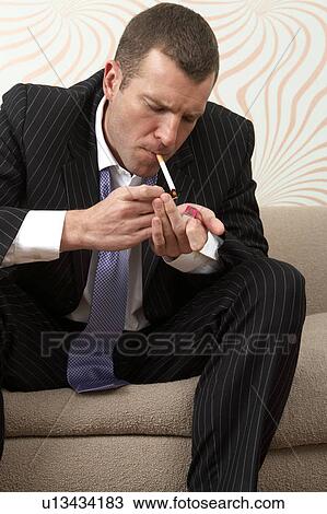 Businessman smoking a cigarette View Large Photo Image Stock Image - Businessman smoking a cigarette. Fotosearch