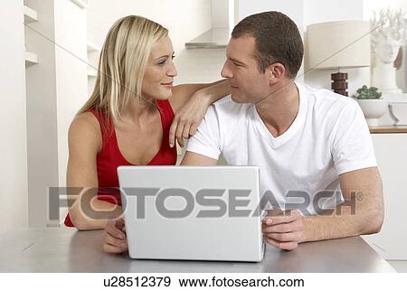 Young couple working from home View Large Photo Image Stock Photo - Young couple working from home. Fotosearch