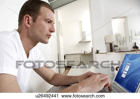 Young man working from home View Large Photo Image Stock Image - Young man working from home. Fotosearch