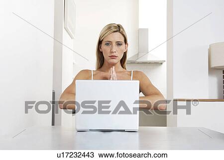 Young woman practicing yoga while working from home View Large Photo Image Stock Image - Young woman practicing yoga while working from home. Fotosearch