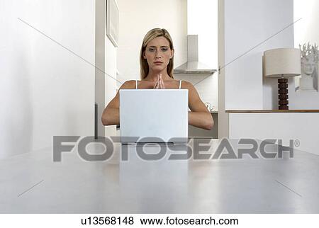 Young woman practicing yoga while working from home View Large Photo Image Stock Photo - Young woman practicing yoga while working from home. Fotosearch