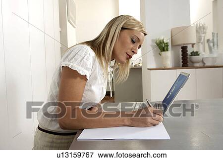 Young woman working from home View Large Photo Image Stock Photo - Young woman working from home . Fotosearch