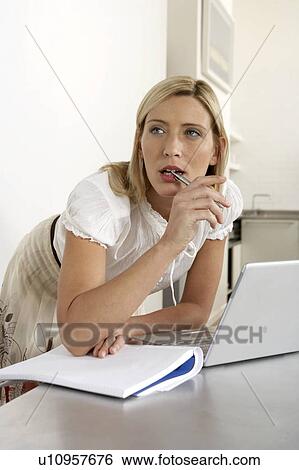 Young woman working from home View Large Photo Image Stock Photograph - Young woman working from home . Fotosearch