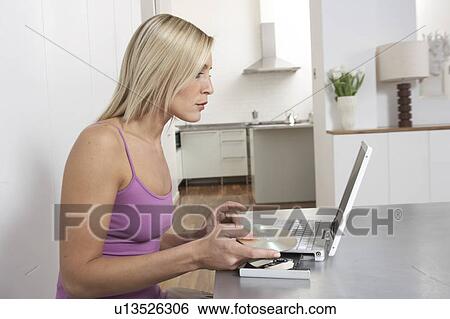 Young woman working from home View Large Photo Image Stock Photograph - Young woman working from home . Fotosearch