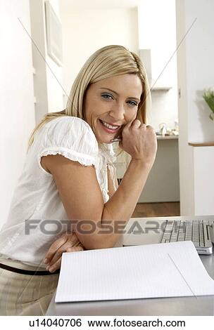 Young woman working from home View Large Photo Image Stock Photograph - Young woman working from home . Fotosearch