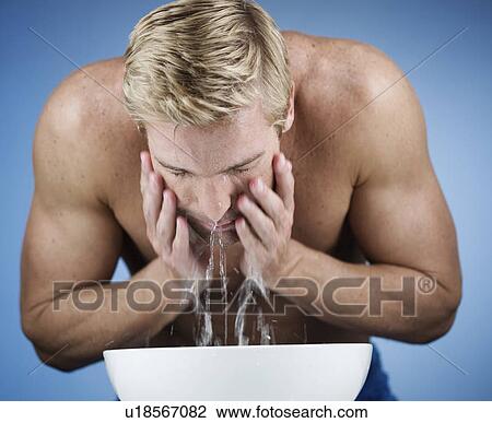 A young man washing his face View Large Photo Image Stock Image - A young man washing his face. Fotosearch