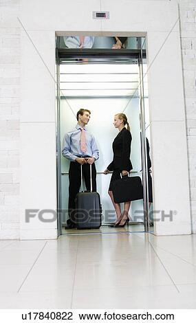 A businessman and woman with suitcases View Large Photo Image Stock Image - A businessman and woman with suitcases. Fotosearch