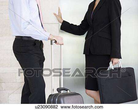 A businessman and woman with suitcases View Large Photo Image Stock Image - A businessman and woman with suitcases. Fotosearch