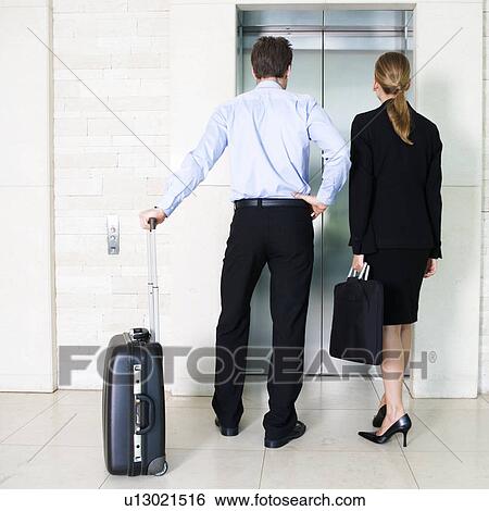 A businessman and woman with suitcases View Large Photo Image Stock Photograph - A businessman and woman with suitcases. Fotosearch