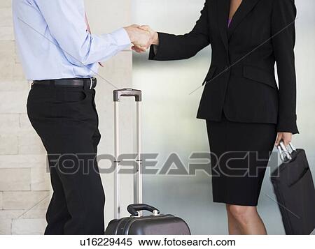 A businessman and woman with suitcases View Large Photo Image Stock Photography - A businessman and woman with suitcases. Fotosearch