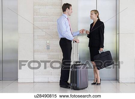 A businessman and woman with suitcases View Large Photo Image Stock Photography - A businessman and woman with suitcases. Fotosearch