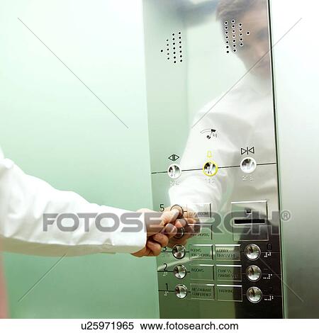 A businessman calling a lift View Large Photo Image Stock Photography - A businessman calling a lift. Fotosearch