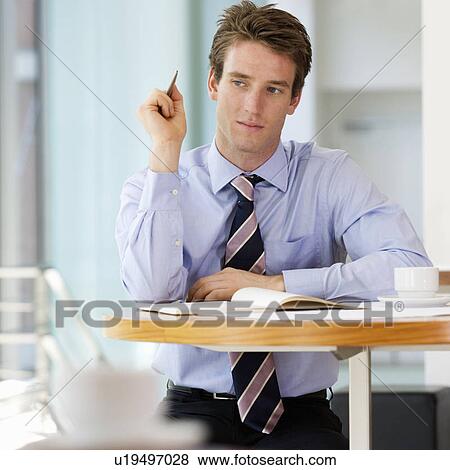 Stock Photo - A businessman making a diary appointment. Fotosearch
