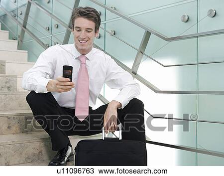 Stock Image - A businessman sitting on steps. Fotosearch