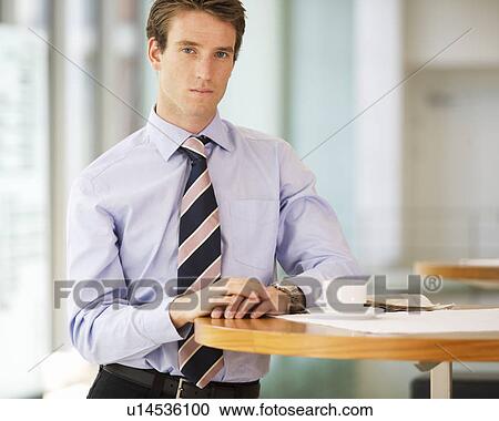 A businessman standing in a hotel lobby View Large Photo Image Stock Image - A businessman standing in a hotel lobby. Fotosearch
