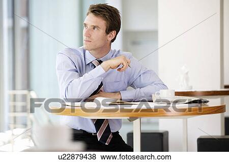 A businessman waiting in a hotel lobby View Large Photo Image Stock Photo - A businessman waiting in a hotel lobby. Fotosearch