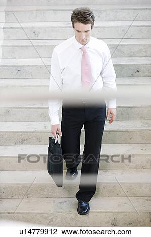 A businessman walking down stairs View Large Photo Image Stock Image - A businessman walking down stairs. Fotosearch