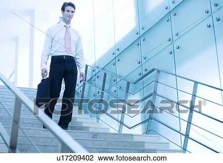 A businessman walking down stairs View Large Photo Image Stock Image - A businessman walking down stairs. Fotosearch
