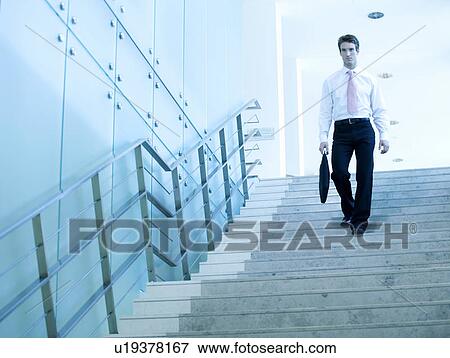 Stock Photo - A businessman walking down stairs. Fotosearch