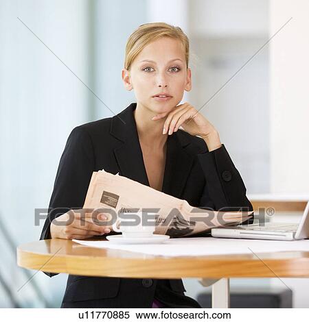 Stock Photography - A businesswoman reading a paper. Fotosearch