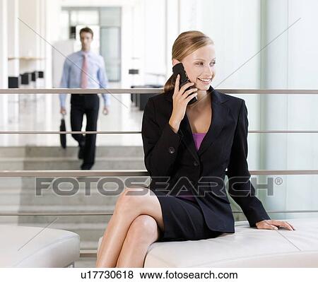 Stock Photo - A businesswoman talking on a mobile phone. Fotosearch