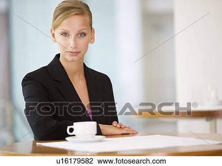 Stock Image - A businesswomen drinking coffee. Fotosearch
