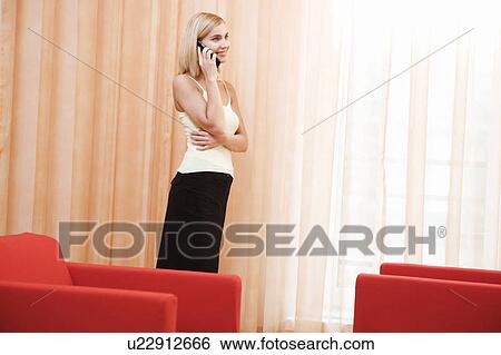 Stock Photograph - A woman talking on a mobile phone. Fotosearch