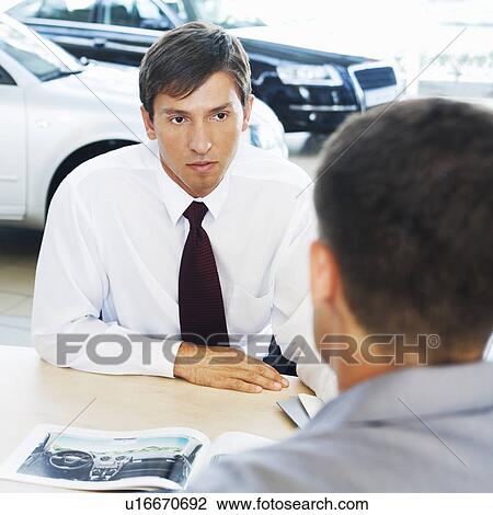 Stock Image - A salesman talking to a customer. Fotosearch