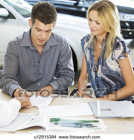 A young couple buying a new car View Large Photo Image Picture - A young couple buying a new car. Fotosearch