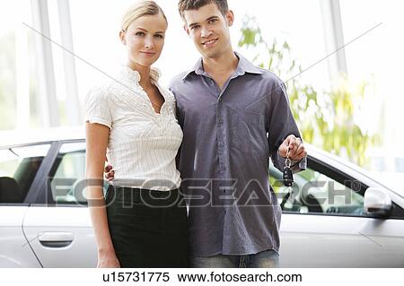 A young couple with keys to a new car View Large Photo Image Stock Photography - A young couple with keys to a new car. Fotosearch