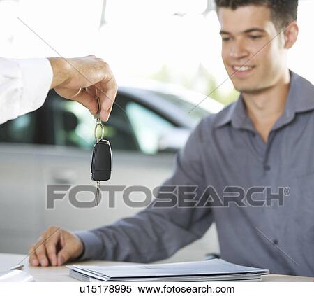 Stock Photography - A young man buying a new car. Fotosearch