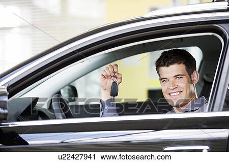 A young man with keys to a new car View Large Photo Image Stock Image - A young man with keys to a new car. Fotosearch