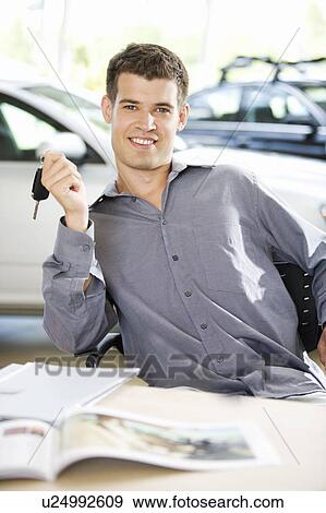 A young man with keys to a new car View Large Photo Image Stock Photo - A young man with keys to a new car. Fotosearch