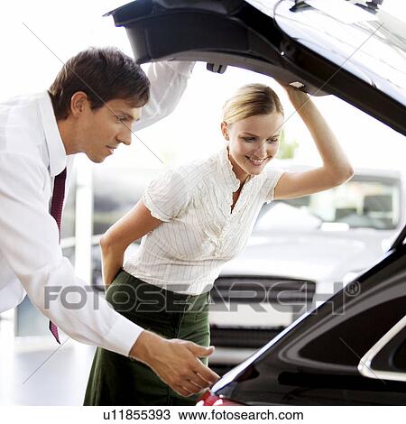 A young woman admiring a new car View Large Photo Image Stock Image - A young woman admiring a new car. Fotosearch