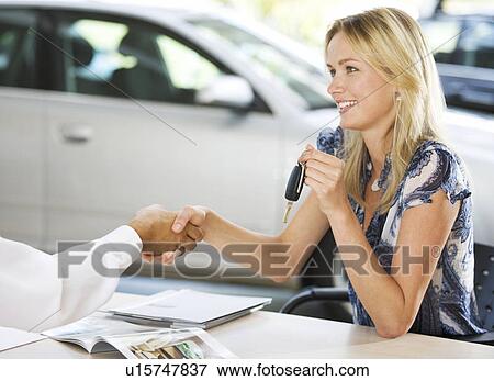 A young woman buying a new car View Large Photo Image Stock Photo - A young woman buying a new car. Fotosearch
